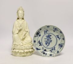 A Chinese Ming blue and white dish and a figure of Guanyin, largest 26cm high