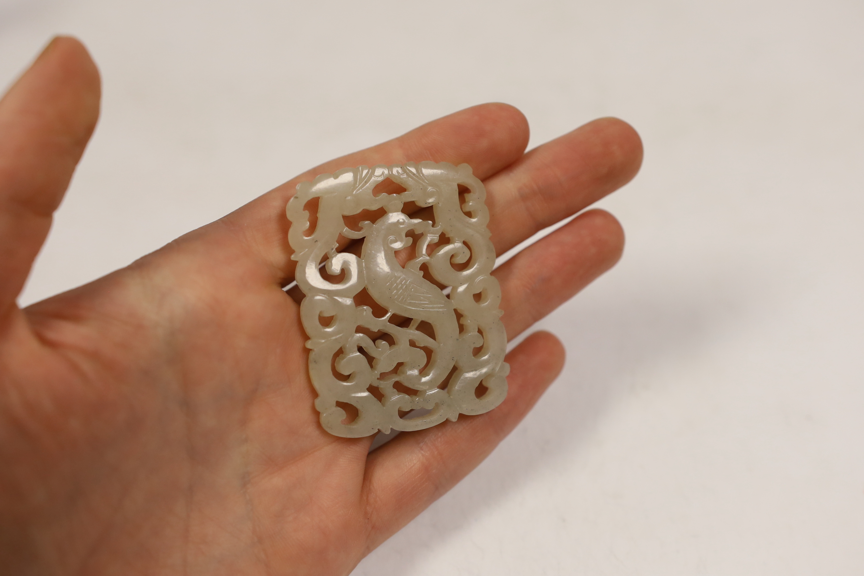 A Chinese jade ‘phoenix’ plaque, late 19th/early 20th century, 5.5 x 4.4cm on hardwood stand, - Image 3 of 3