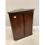 A George III oak hanging corner cupboard, width 70cm, depth 41cm, height 82cm