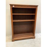 An Edwardian carved oak open bookcase, width 99cm, depth 30cm, height 138cm