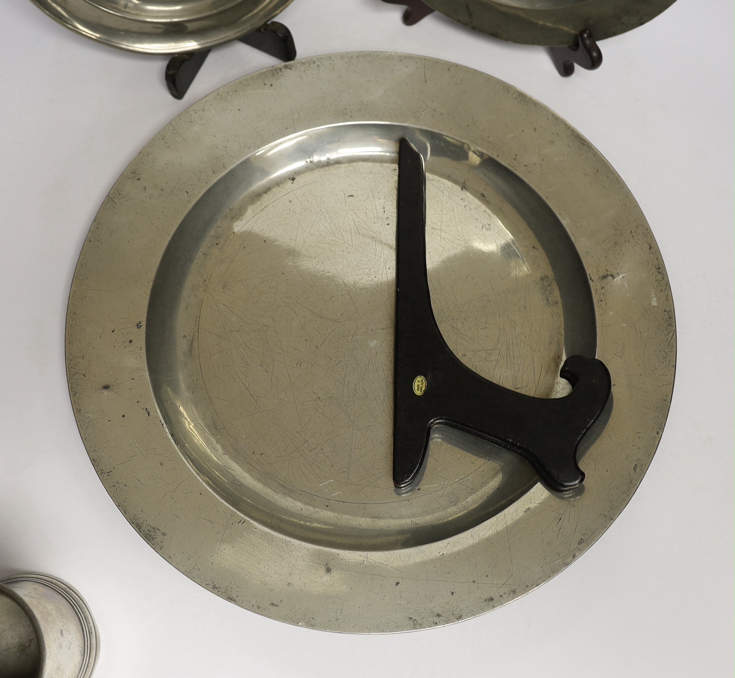 Four 18th century and later pewterware items including a charger, 41.5cm diameter, two plates, and a - Image 3 of 4