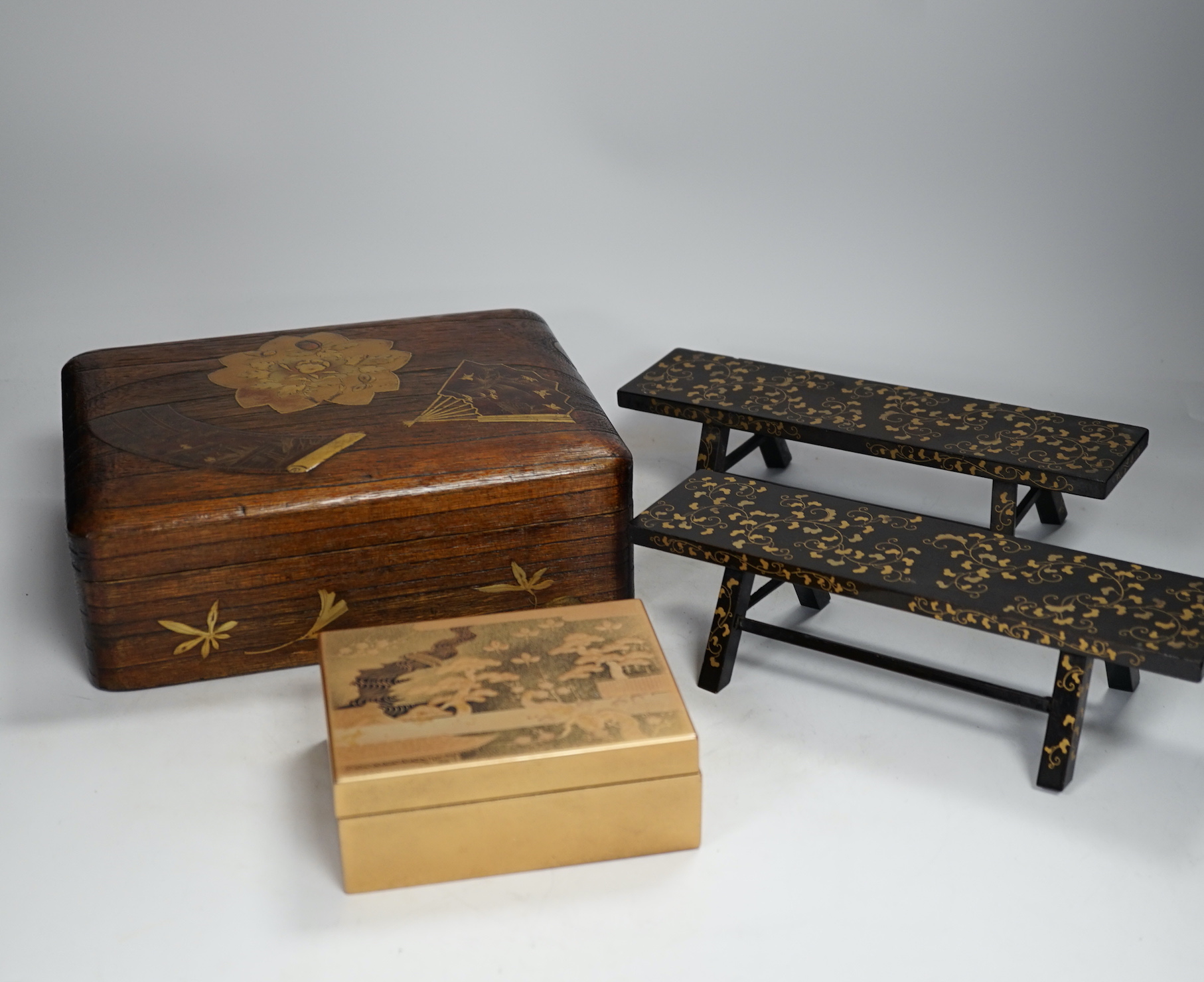 A group of Japanese lacquer wares, comprising pair of miniature benches and two boxes, Meiji