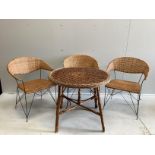 A circular wicker table, diameter 83cm, height 70cm together with three wicker tub framed chairs