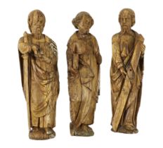 A set of three 18th century Continental carved wood figures of Saints, holding a cross, a bible