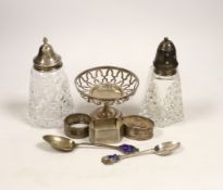 A group of small silver including two mounted glass sugar sifters, three assorted napkin rings,