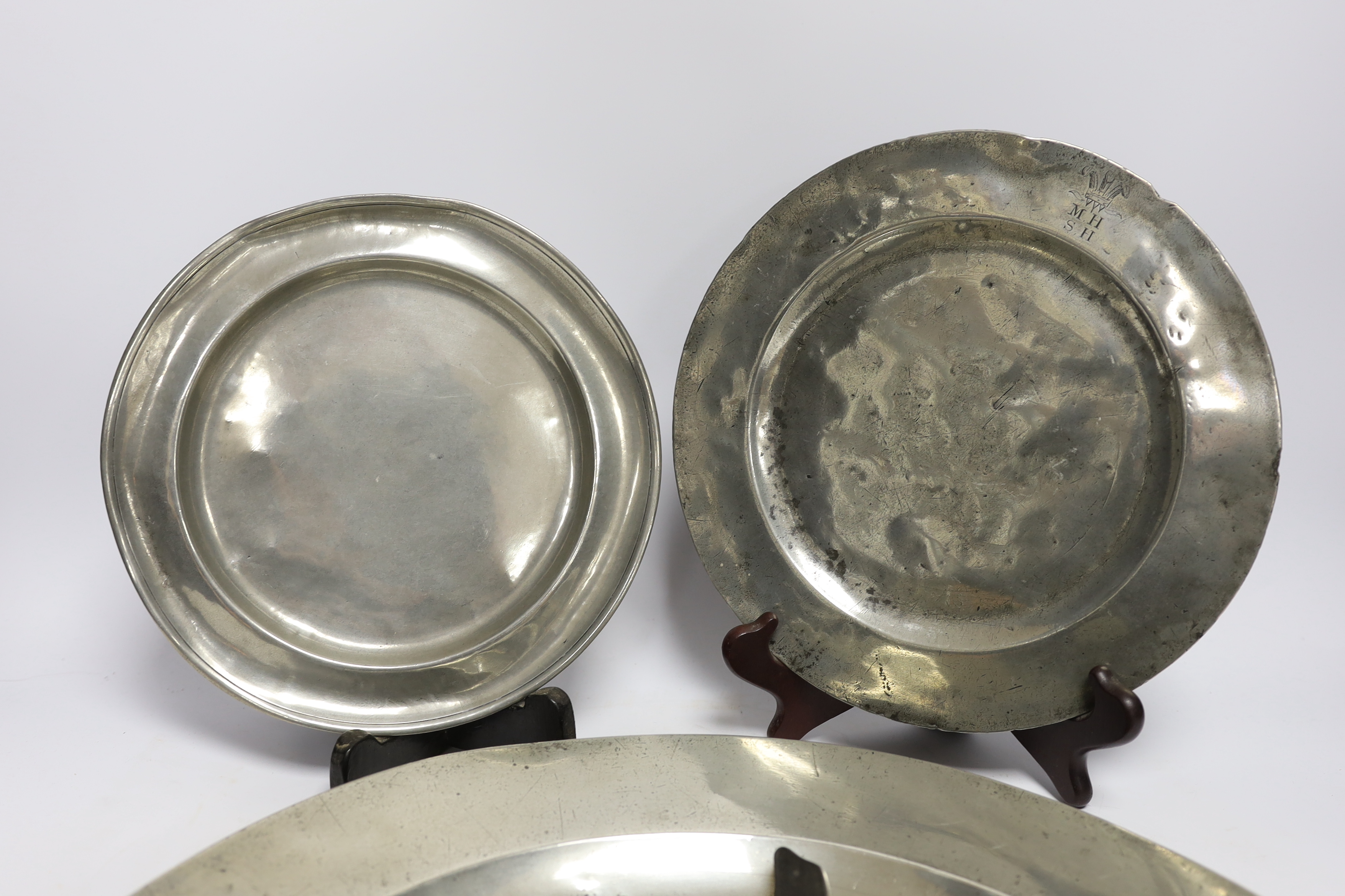 Four 18th century and later pewterware items including a charger, 41.5cm diameter, two plates, and a - Image 4 of 4