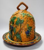 A Minton style Majolica cheese dish and cover decorated in relief, restored handle, 35cm