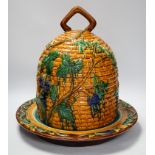 A Minton style Majolica cheese dish and cover decorated in relief, restored handle, 35cm