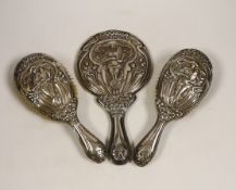 An Edwardian Art Nouveau silver mounted hand mirror and hair brush, maker Charles Horner?,