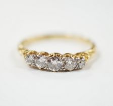 An 18ct and graduated five stone diamond set half hoop ring, size P/Q, gross weight 2.7 grams.