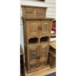 A late Victorian carved oak side cabinet, altered, width 68cm, depth 41cm, height 174cm