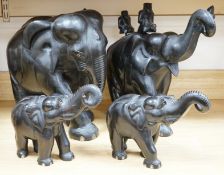 Two large carved ebony elephants and two smaller similar elephants