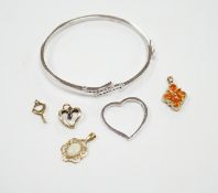 A 9ct white gold heart pendant, a 9kt bangle, two 9ct and gem set pendants and two yellow metal