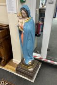 A large painted plaster floor standing statue of Madonna and child, height 130cm