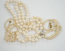 A single strand cultured pearl necklace with 18k white metal clasp, 88cm and two other similar