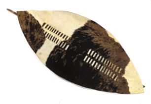 A large Ishilunga cowhide shield of conventional form with wooden stiffener, 148cm