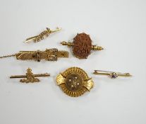 Four assorted yellow metal and gem set bar brooches including sapphire and diamond chip set buckle