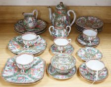 A Chinese famille rose part tea set including: five cups saucers and side plates, a teapot and