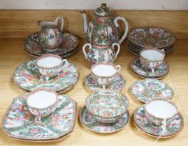 A Chinese famille rose part tea set including: five cups saucers and side plates, a teapot and