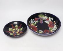 Two Moorcroft Orchid pattern bowls, largest 26cm diameter