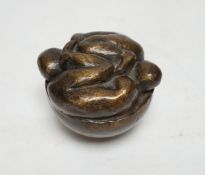 A squat bronze paper weight, the top of two intertwined figures, 8cm high