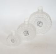 Three graduated Lalique Dahlia pattern glass scent bottles and stoppers, signed to the bases,