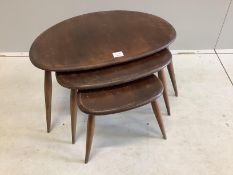 A nest of three Ercol elm "Pebble" tables, width 66cm, depth 44cm, height 40cm