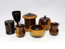 A collection of 19th/20th century lignum vitae vessels, including a turned string box and cover,