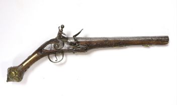 A Turkish Flintlock holster pistol with brass mounts, long spur butt cap, engraved lock and carved