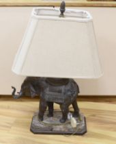 A bronzed elephant table lamp raised on shaped base, with shade, 79cm high