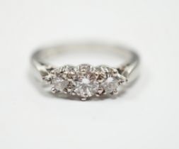 A modern platinum and three stone diamond set ring, size J, gross weight 4.6 grams.