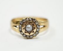 An Edwardian 18ct gold, rose cut diamond and split pearl cluster set ring, size O, gross weight 3.