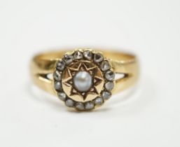 An Edwardian 18ct gold, rose cut diamond and split pearl cluster set ring, size O, gross weight 3.