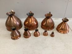 A matched graduated set of nine late 19th / early 20th century copper haystack measures, four
