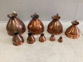 A matched graduated set of nine late 19th / early 20th century copper haystack measures, four