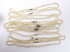 A collection of nine assorted cultured pearl necklaces with 9ct or yellow metal clasps.