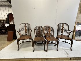 A set of six reproduction elm and beech Windsor wheel back dining chairs on cabriole legs with