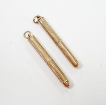 Two engine turned 9ct gold cased propelling toothpicks, 43mm.
