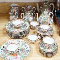 A Chinese famille rose six place setting tea service, including a large tea pot and cover, a smaller