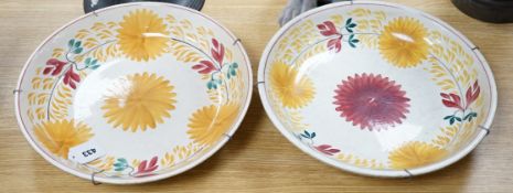 A George Jones & Sons crescent pottery floral wall plate and a similar Staffordshire example, 37cm