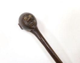 An African carved ebony walking stick, Gogo tribe, Tanzania, with inset eyes, 128cm (damage to