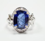 A modern 10k white metal, sapphire and diamond chip set oval cluster set dress ring, size M, gross