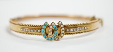 A 9ct gold, seed pearl and turquoise set twin horseshoe motif hinged bangle, gross weight 7.5