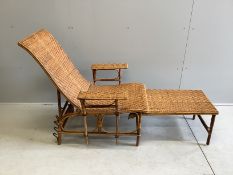An early 20th century French caned bamboo reclining garden chair, with integral footrest, width