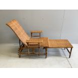 An early 20th century French caned bamboo reclining garden chair, with integral footrest, width