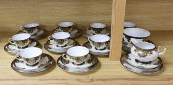 A Japanese Noritake floral and gilt tea set, comprising a sugar bowl, a milk jug, nine cups, plus