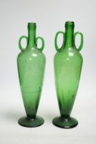 A pair of double handle green glass vases, 33cm