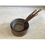 A graduated set of five circular copper saucepans, largest diameter 20cm