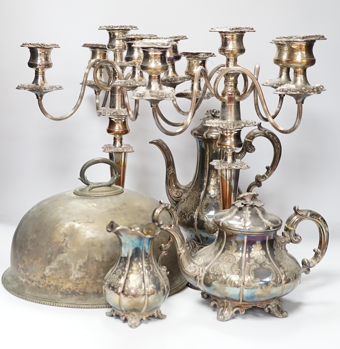A quantity of silver plated wares to include a three piece tea set, tureen cover and pair of