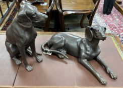 Two large bronze models of seated dogs, largest 57cm wide